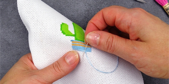Person doing a cross stitch