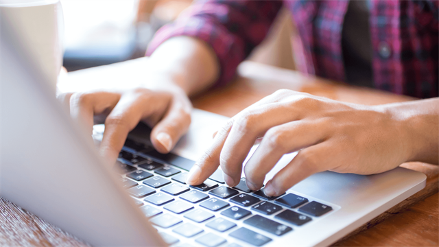 Person typing on laptop