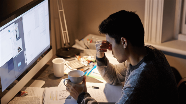 Student at computer looking upset