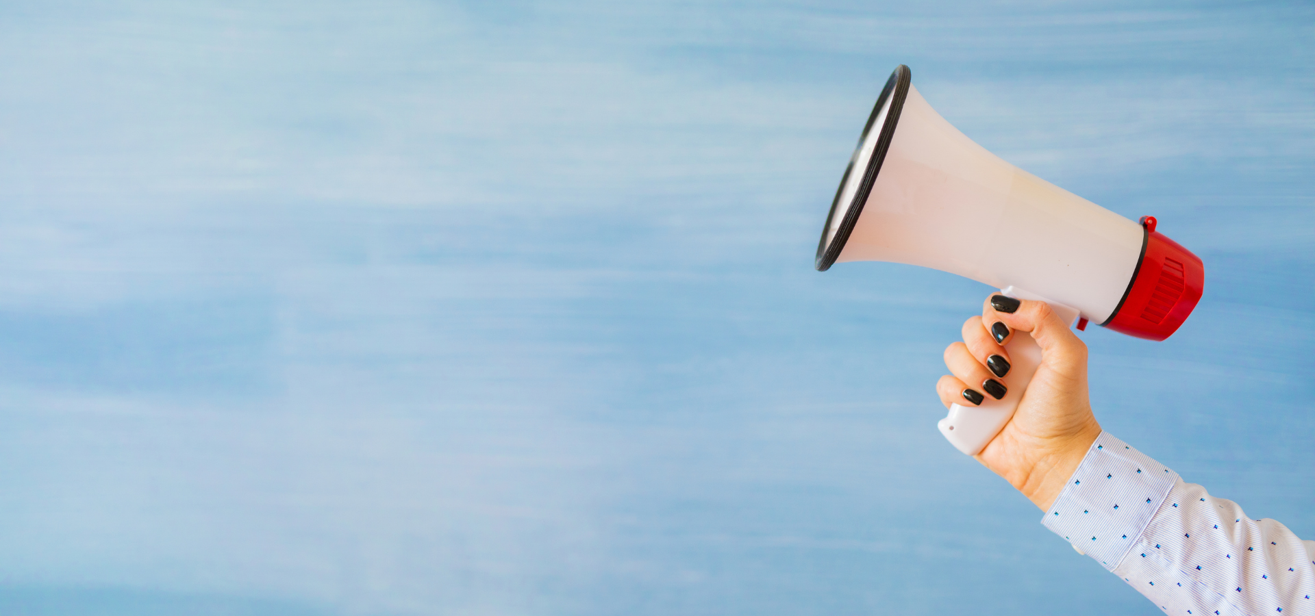 Hand holding a loud speaker