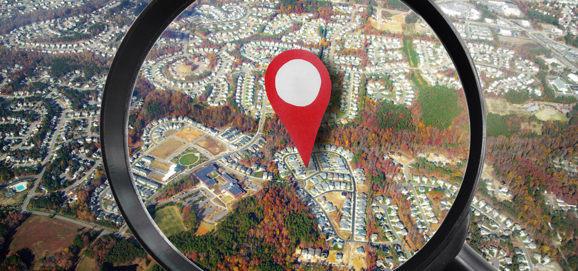 Aerial view of houses, with a magnifying glass