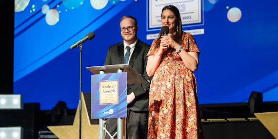 2 People on stage presenting awards