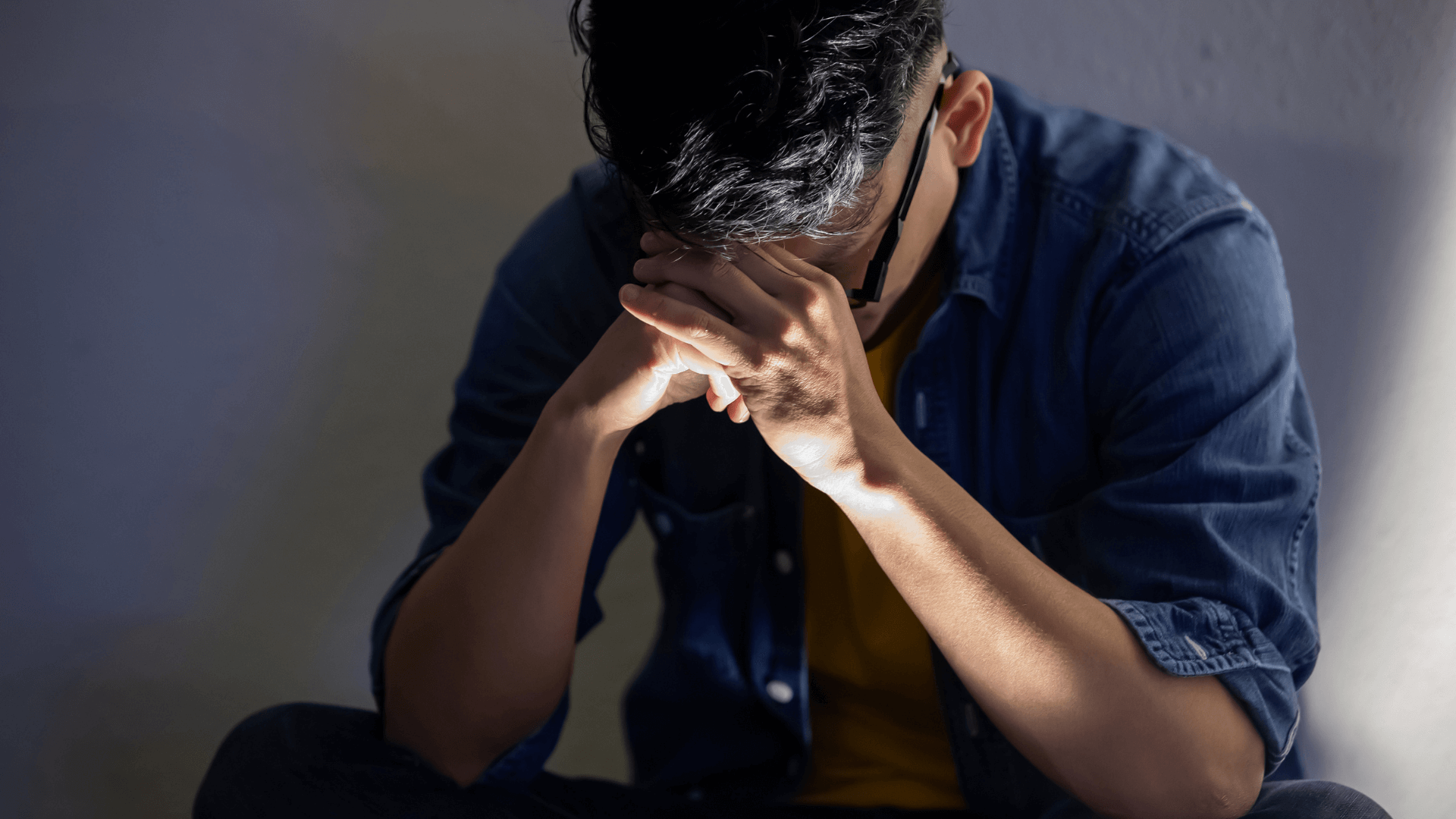 man holding head in his hands