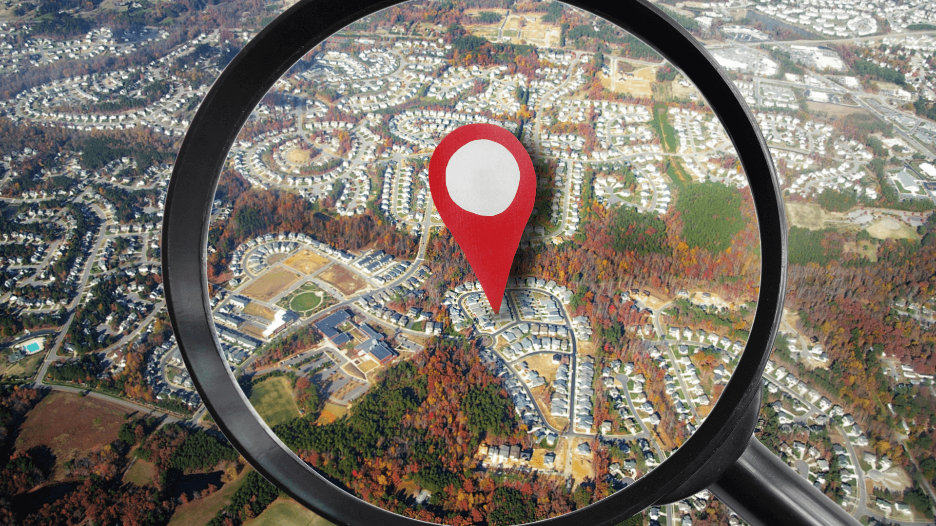 Magnifying glass over a house on a map