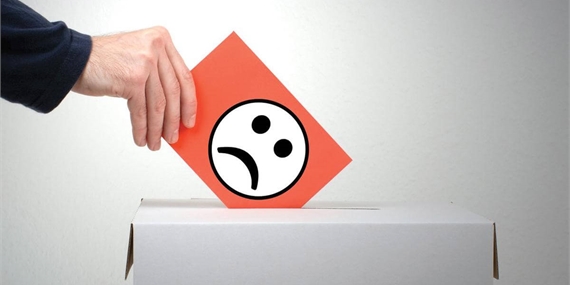 Person submitting a piece of paper with an unhappy face