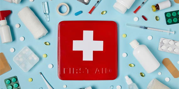 First aid kit with medical supplies around it
