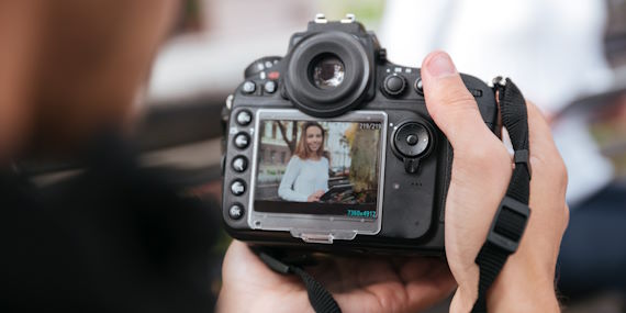 Person holding a camera taking a photo