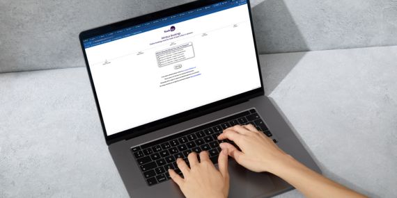 Student with laptop in front booking online.