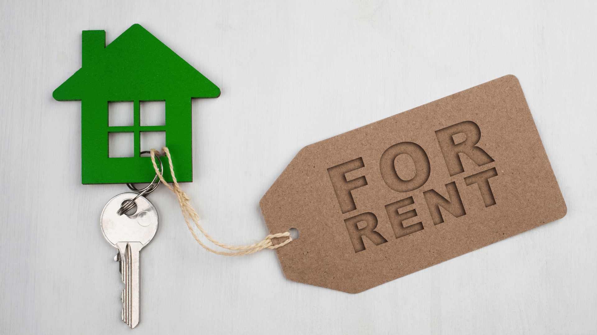 Key on a house-shaped keyring, with a label saying 'for rent'